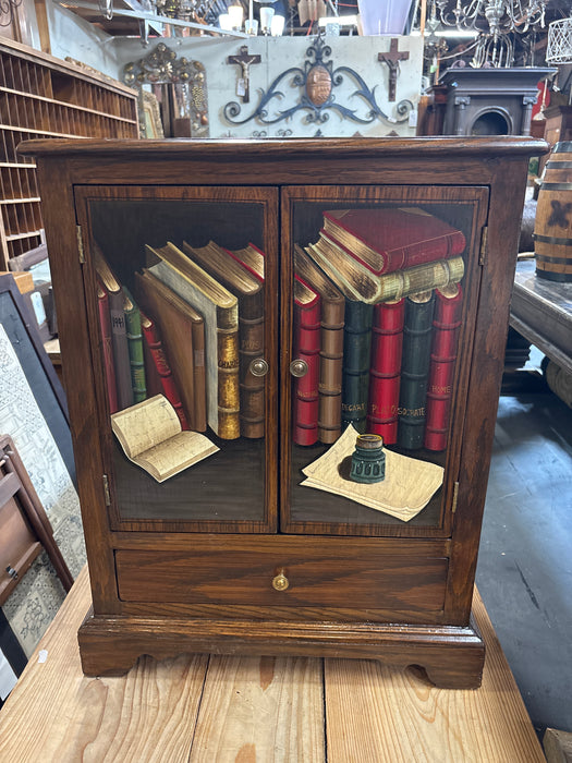 SMALL OAK CABINET WITH BOOK PAINTED DOORS AND DRAWER