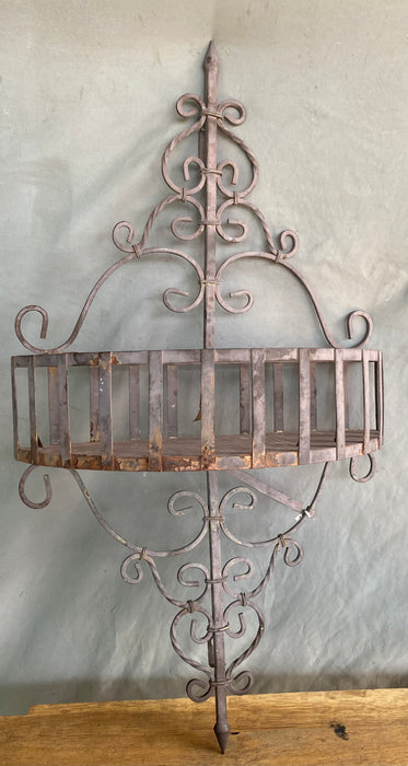 METAL WALL PLANTER ON BROWN SHELF