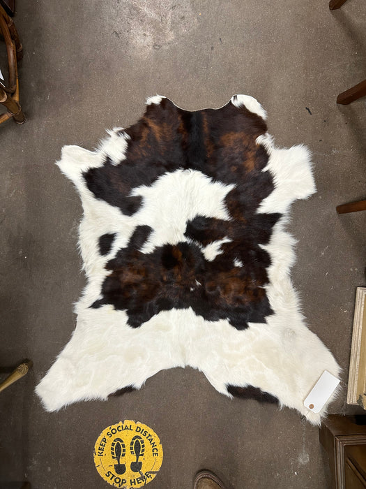 SMALL BROWN AND WHITE COWHIDE RUG