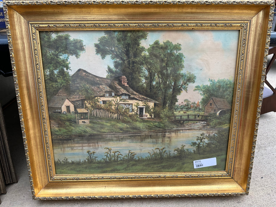 NICELY FRAMED ARTWORK OF A HOUSE ON A BROOK