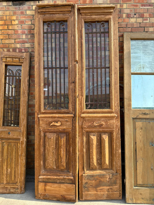 PAIR OF TALL SLENDER EGYPTIAN PRIMITIVE IRON INSET WOOD DOORS WITH PYRAMODAL BLOCKS