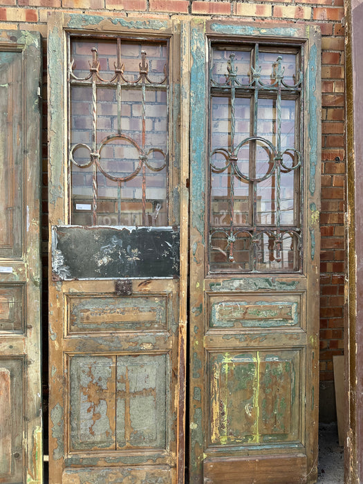 PAIR OF GREEN DISTRESSED EGYPTIAN IRON INSET WOOD DOORS