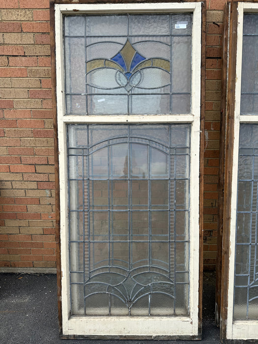 TALL STAINED GLASS WINDOW WITH YELLOW AND BLUE TOP OPEN TRANSOM