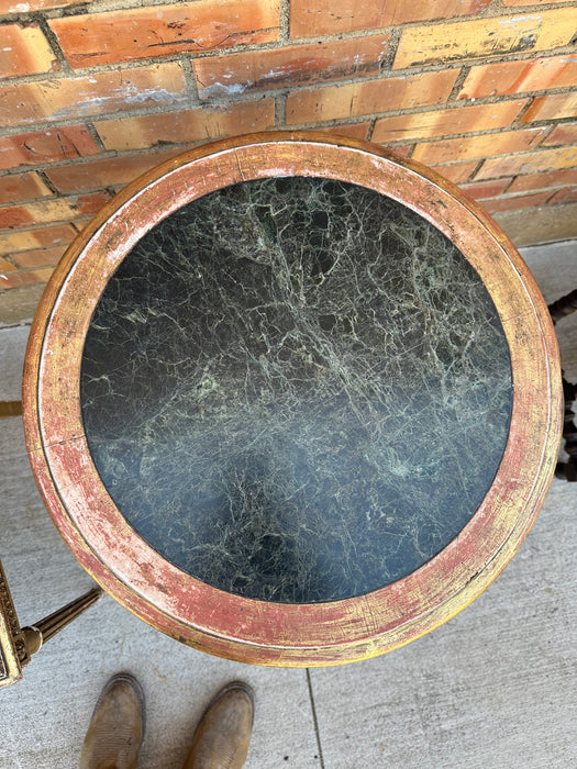 GILT TRI-FOOT ROUND TABORET ON TABLE