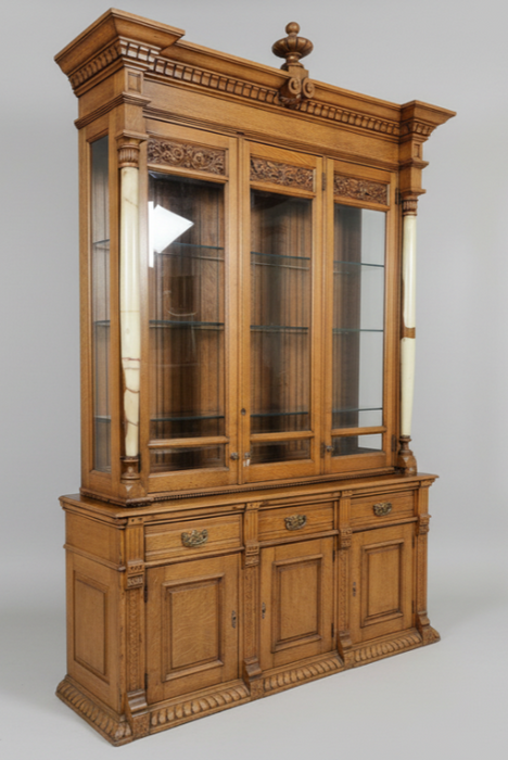 TALL 2 PIECE AMERICAN OAK DISPLAY CABINET WITH BEVELED GLASS DOORS, GLASS SHELVES AND ONYX COLUMNS