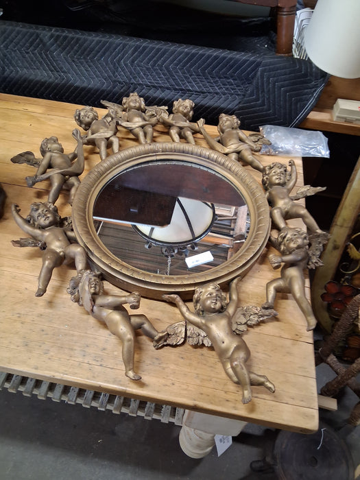 ROUND ITALIAN MIRROR SURROUNDED BY CARVED CHERUBS