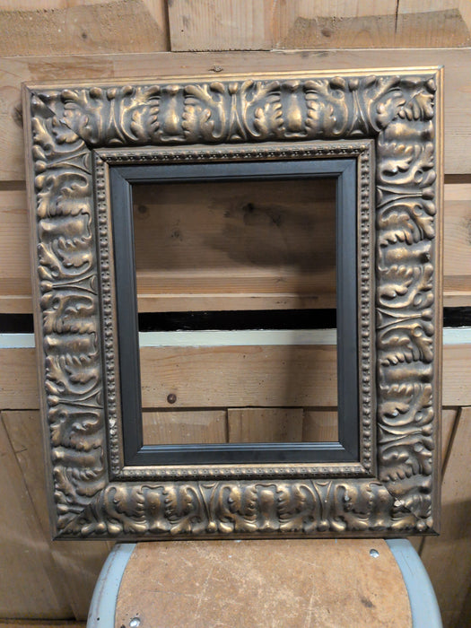 GILT CARVED WOOD FRAME WITH BLACK LINER