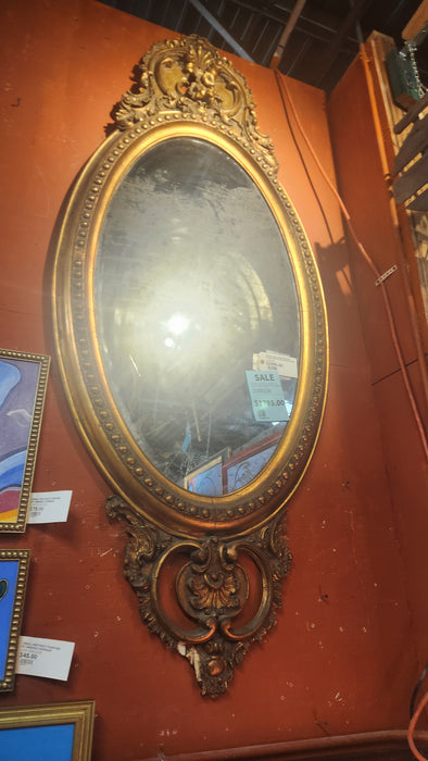 PERIOD OVAL GOLD MIRROR IN ORNATE WOOD AND GESSO FRAME