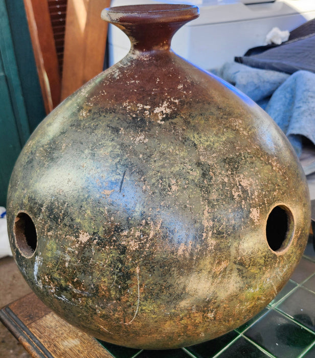LARGE BROWN POTTERY JUG WITH NARROW NECK AND DECORATIVE HOLES IN BODY