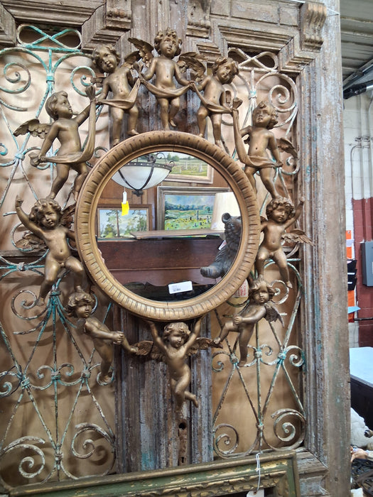 ROUND ITALIAN MIRROR SURROUNDED BY CARVED CHERUBS