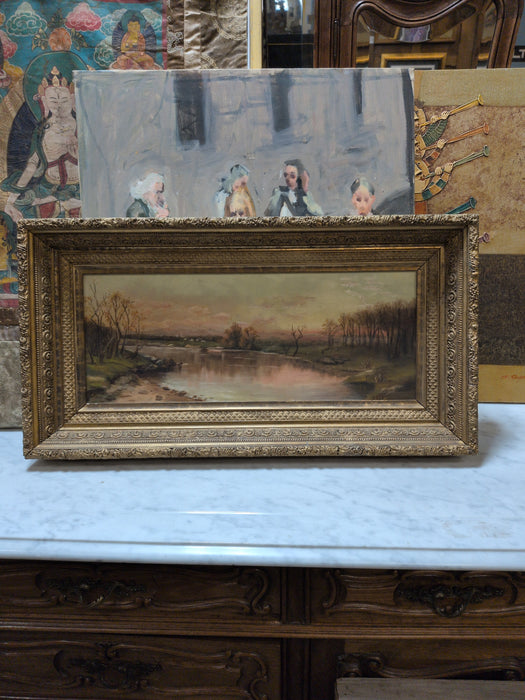 GOLD FRAMED OIL PAINTING OF TREES AROUND LAKE