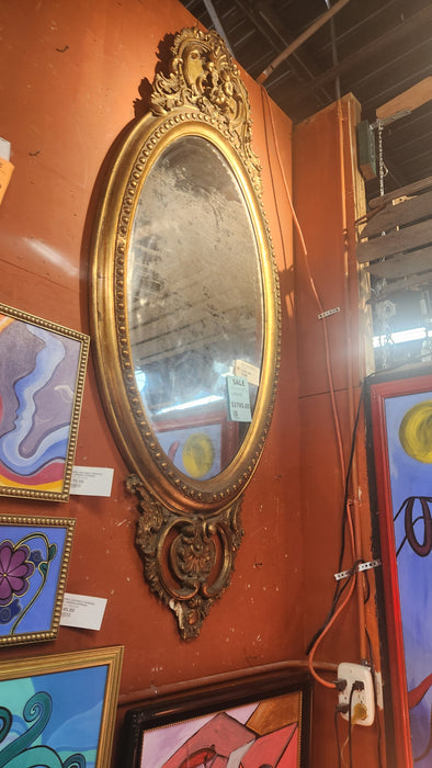 PERIOD OVAL GOLD MIRROR IN ORNATE WOOD AND GESSO FRAME