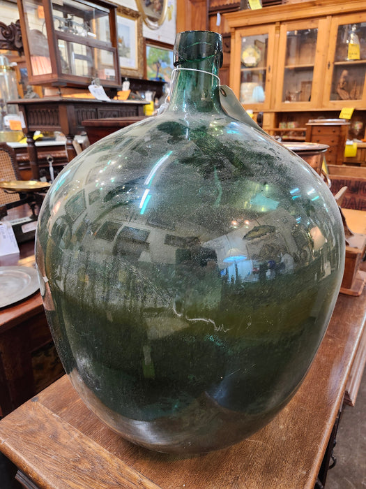 LARGE WINE BOTTLE IN BASKET