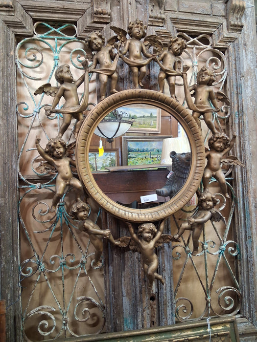 ROUND ITALIAN MIRROR SURROUNDED BY CARVED CHERUBS