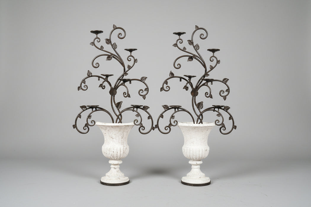 PAIR OF LARGE COMPOSITION IRON PLANTERS WITH CANDLE STANDS