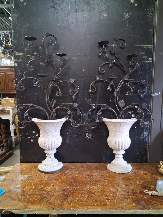 PAIR OF LARGE COMPOSITION IRON PLANTERS WITH CANDLE STANDS