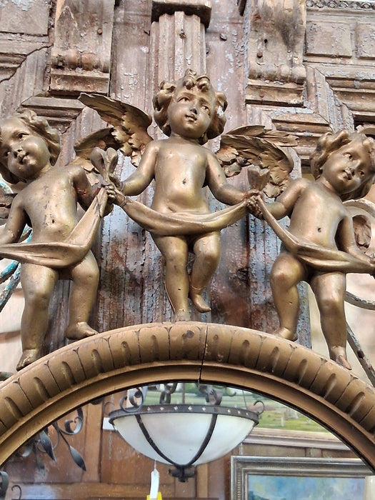 ROUND ITALIAN MIRROR SURROUNDED BY CARVED CHERUBS