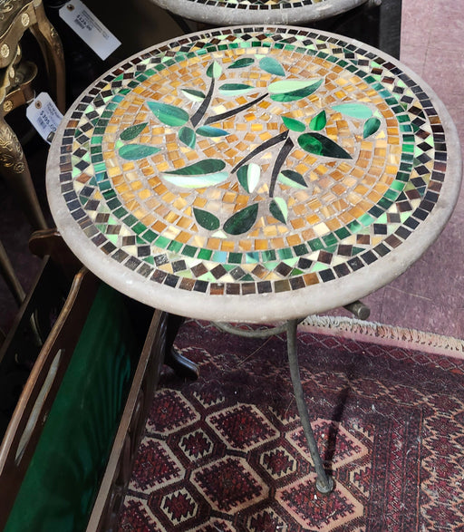 Decorative mosaic table with bird design on a market stall background