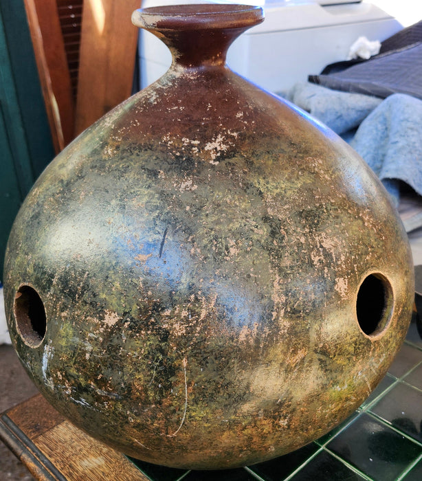 LARGE BROWN POTTERY JUG WITH NARROW NECK AND DECORATIVE HOLES IN BODY