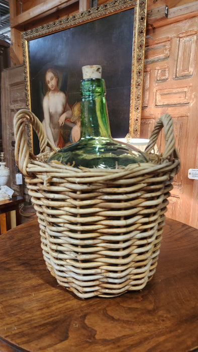SMALL GREEN BOTTLE IN BASKET