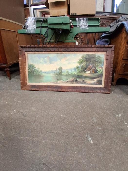 LONG FRAMED LANDSCAPE OF A HUT ON A LAKE