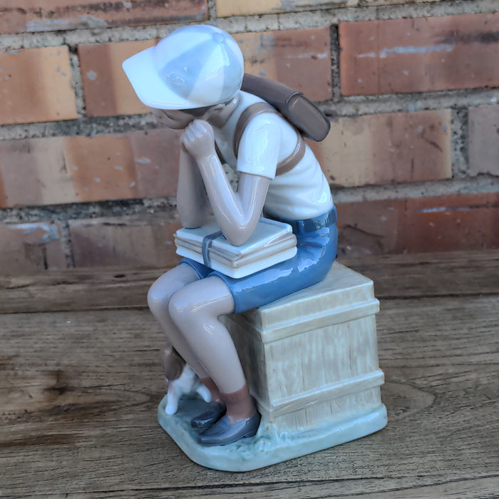 LLADRO FIGURE OF BOY AND HIS DOG SITTING