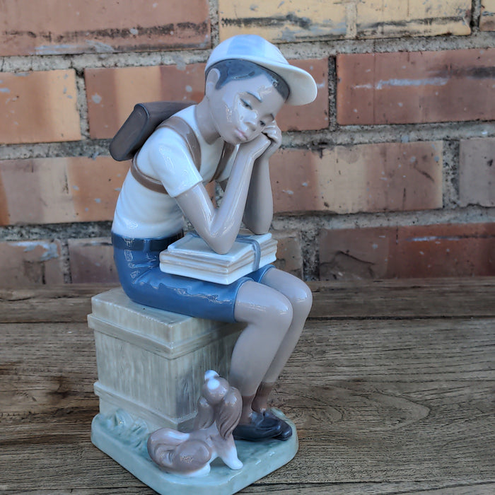 LLADRO FIGURE OF BOY AND HIS DOG SITTING