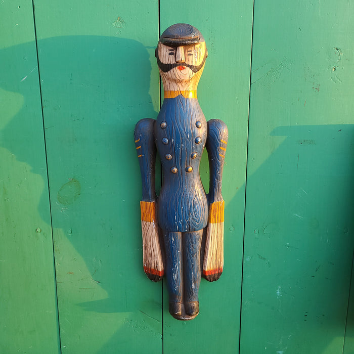 Blue plaster figure of man with windmill arms