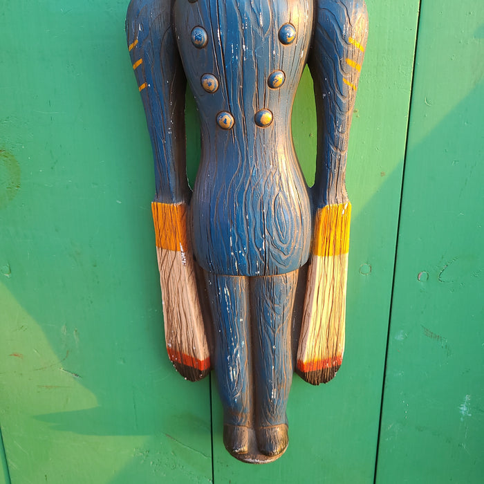 Blue plaster figure of man with windmill arms