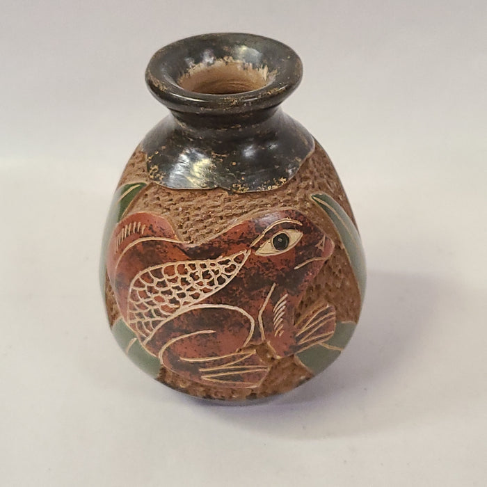 CARVED POTTERY JAR WITH DECOR