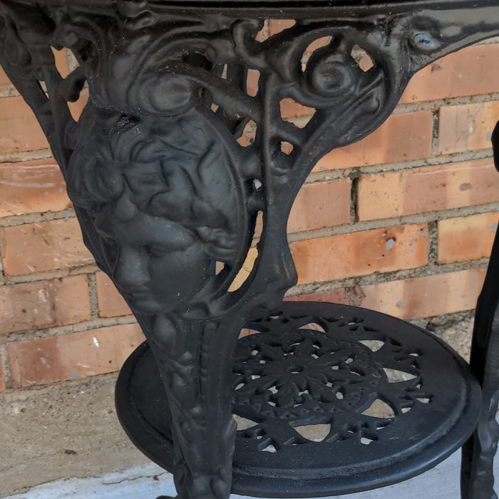 BLACK PAINTED MAHOGANY TOP CAST IRON PUB TABLE WITH FIGURAL MASKS