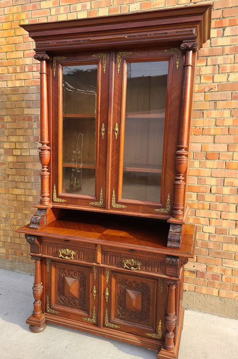AUSTRIAN WALNUT BOOKCASE WITH GLASS UPPER DOORS AND CARVED LOWER DOORS