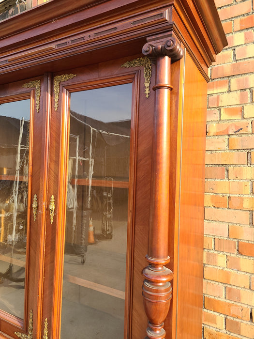 AUSTRIAN WALNUT BOOKCASE WITH GLASS UPPER DOORS AND CARVED LOWER DOORS