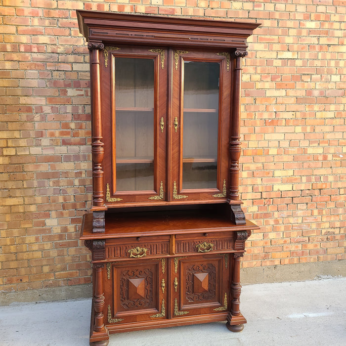 AUSTRIAN WALNUT BOOKCASE WITH GLASS UPPER DOORS AND CARVED LOWER DOORS