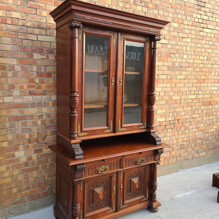 AUSTRIAN WALNUT BOOKCASE WITH GLASS UPPER DOORS AND CARVED LOWER DOORS