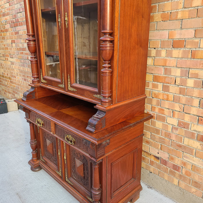 AUSTRIAN WALNUT BOOKCASE WITH GLASS UPPER DOORS AND CARVED LOWER DOORS