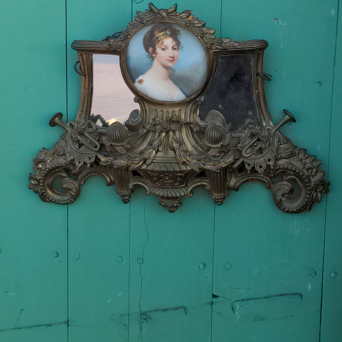 ORNATE ANTIQUE GILT BRASS SMALL WALL MIRROR WITH PORTRAIT IN CENTER