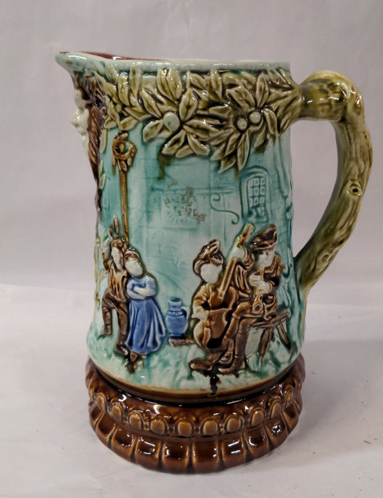 GREEN MAJOLICA PITCHER WITH DANCERS