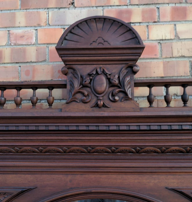 CARVED WALNUT JESTERS MIRROR WITH COLUMNS