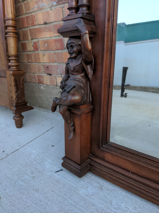 CARVED WALNUT JESTERS MIRROR WITH COLUMNS