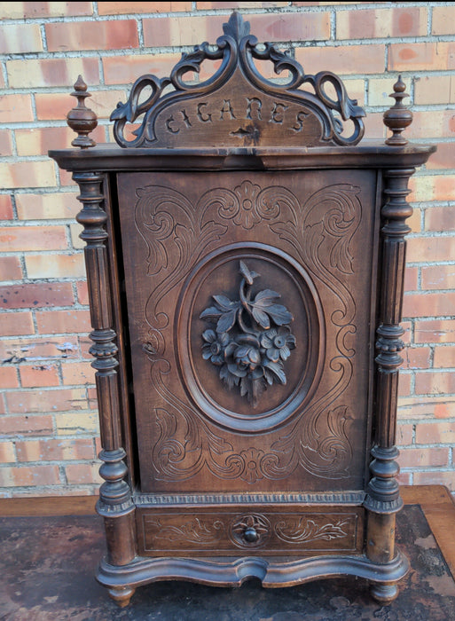 FRENCH  WALNUT TOBACCO CABINET WITH "CIGARES" AND FLORAL CARVED DOOR