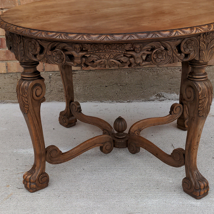 ROUND CARVED OAK LOW OCCASIONAL TABLE, WITH PAW FEET