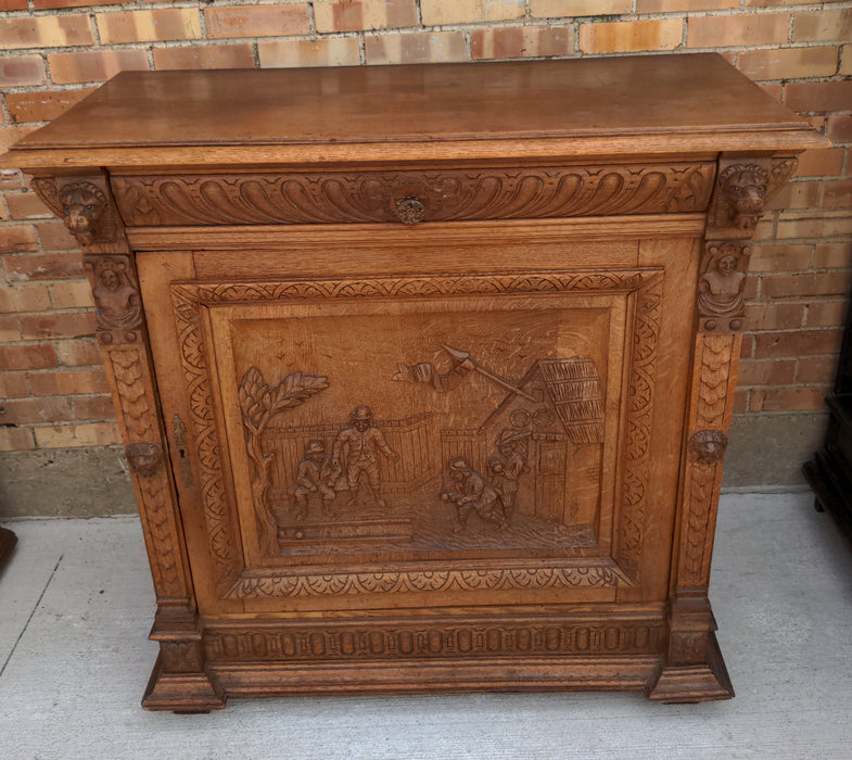 OAK FIGURAL CARVED SINGLE DOOR CABINET WITH LION HEADS