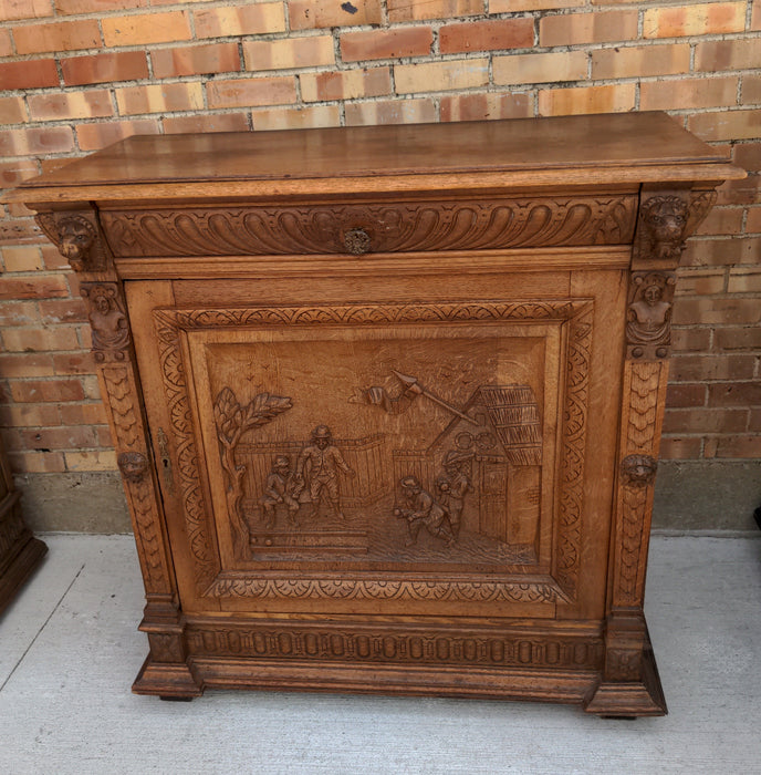 OAK FIGURAL CARVED SINGLE DOOR CABINET WITH LION HEADS