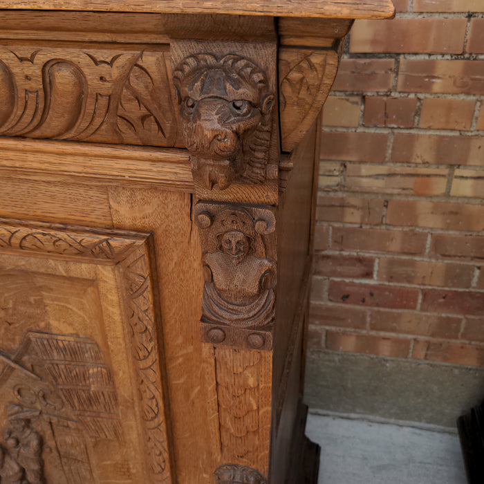 OAK FIGURAL CARVED SINGLE DOOR CABINET WITH LION HEADS