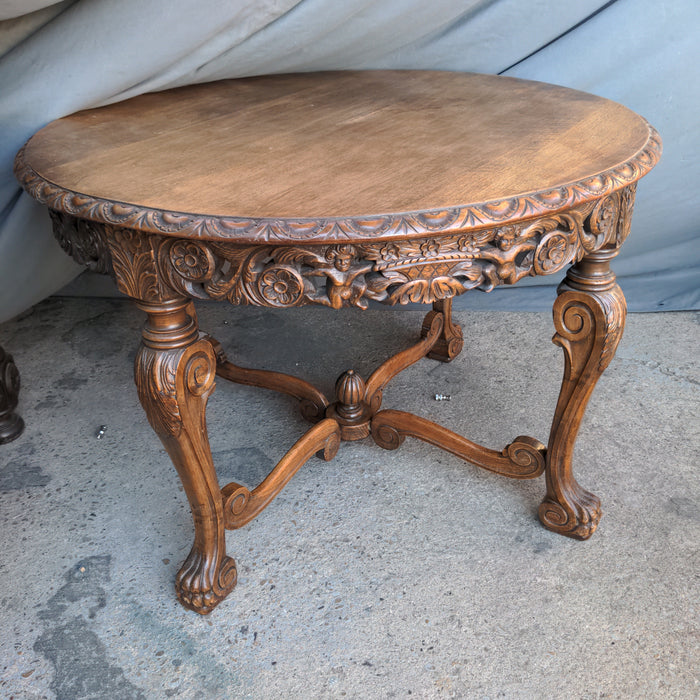 ROUND CARVED OAK LOW OCCASIONAL TABLE, WITH PAW FEET