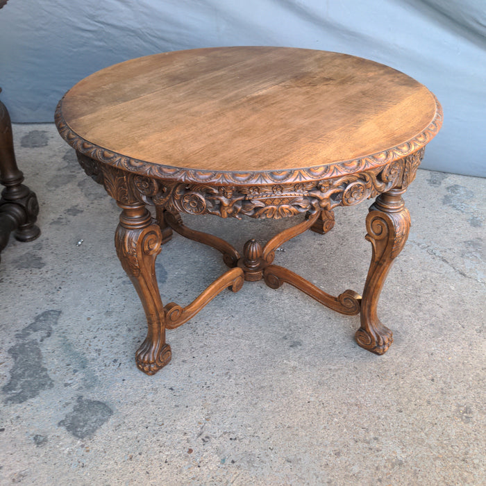 ROUND CARVED OAK LOW OCCASIONAL TABLE, WITH PAW FEET