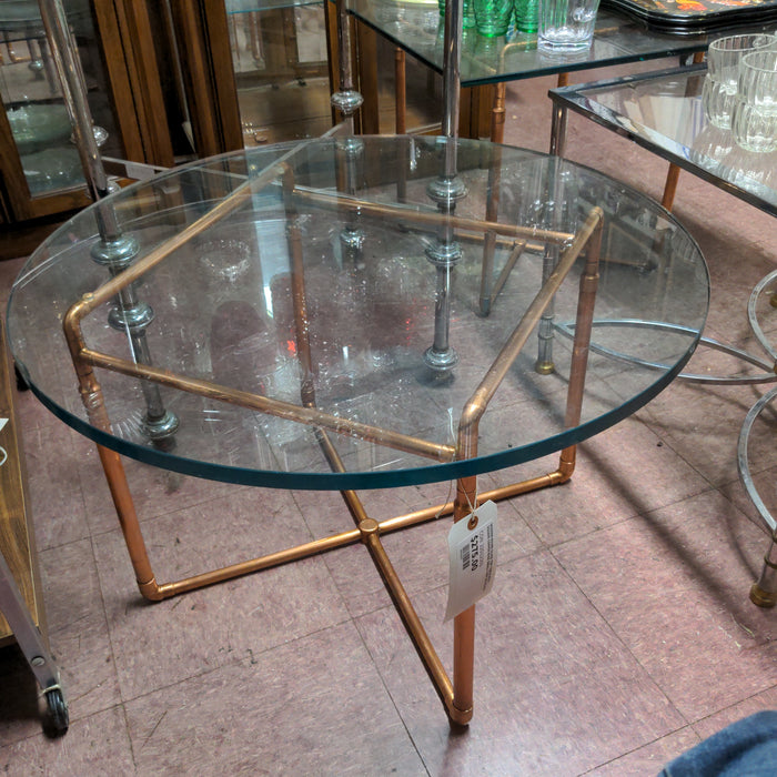 MODERN ROUND GLASS TOP TABLE WITH SQUARE COPPER BASE SMALL CHIP ON GLASS