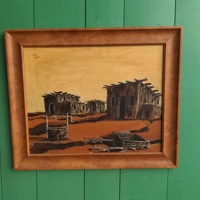 FRAMED ORANGE TONE OIL PAINTING OF A DILAPIDATED TOWN