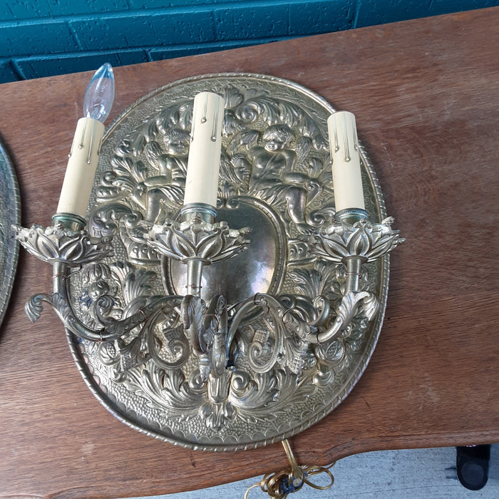 PAIR OF BRASS CHERUB PLAQUES WITH ELECTRIFIED SCONCES
